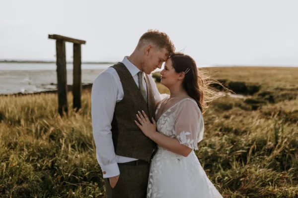 Newlyweds share at a tender moment at their waterside kent wedding venue