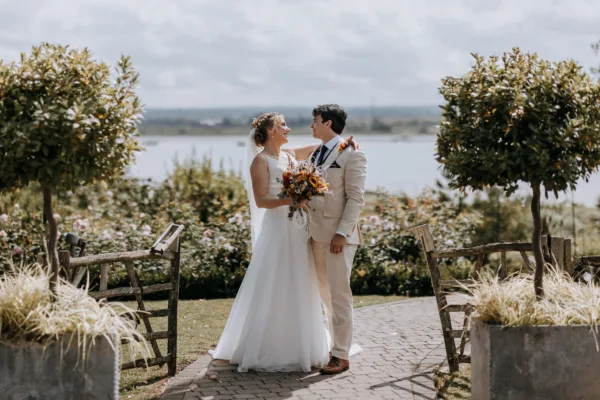 Newlyweds in The Harty Estate wedding garden, overlooking the Kent estuary