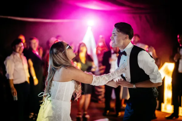 Newlyweds dancing during their evening wedding party at The Harty Estate