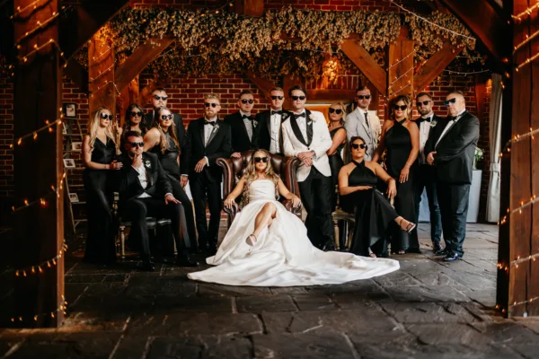 Wedding party pose Godfather style in a Kent wedding barn