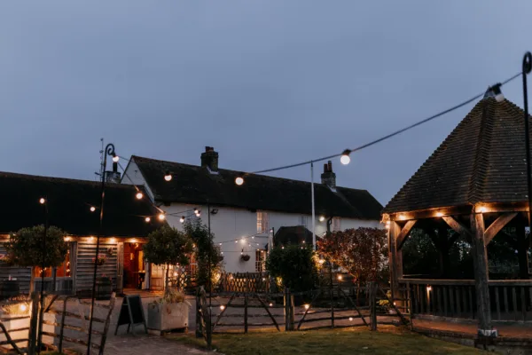 Exterior of the Harty Estate wedding venue lit with festoons