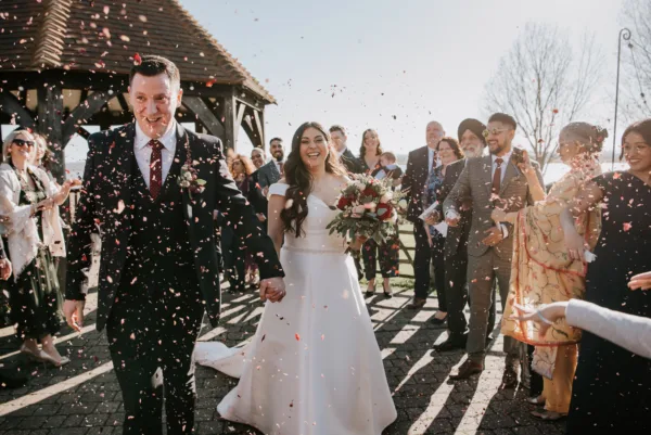 Newlyweds beneath a shower of confetti at The Harty Estate