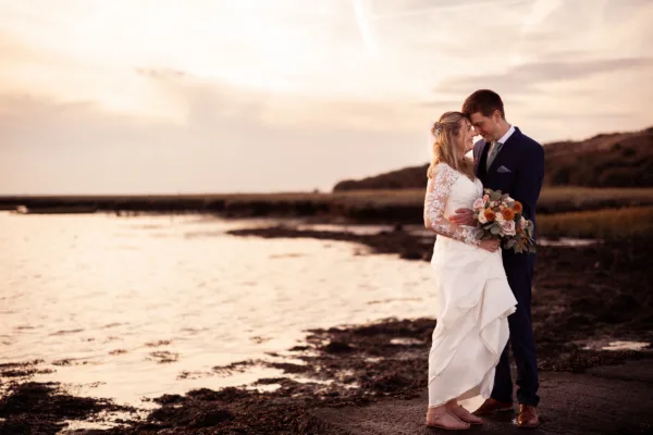 Newlyweds beside the Kent estuary, at The Harty Estate wedding venue