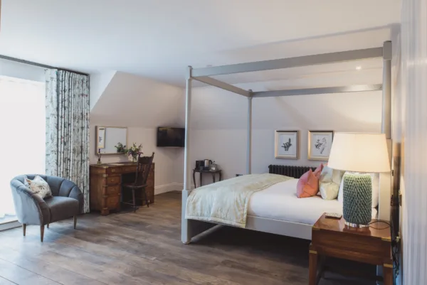 Wedding accommodation with a four poster bed at a barn wedding venue in Kent