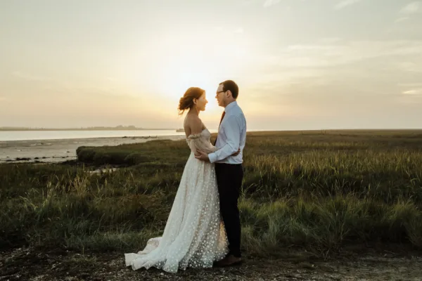 Newlyweds at twilight beside the Kent estuary