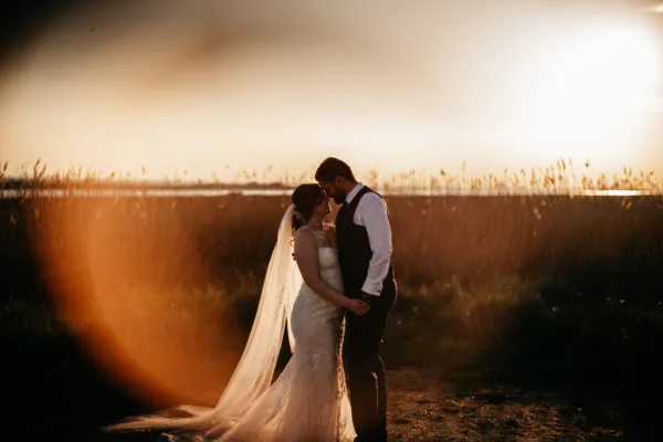 Newlyweds at sunset among the wetlands of The Harty Estate