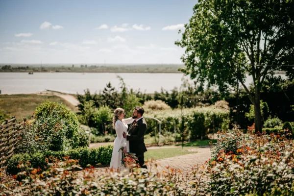 Newlyweds in The Harty Estate wedding garden overlooking the Kent estuary