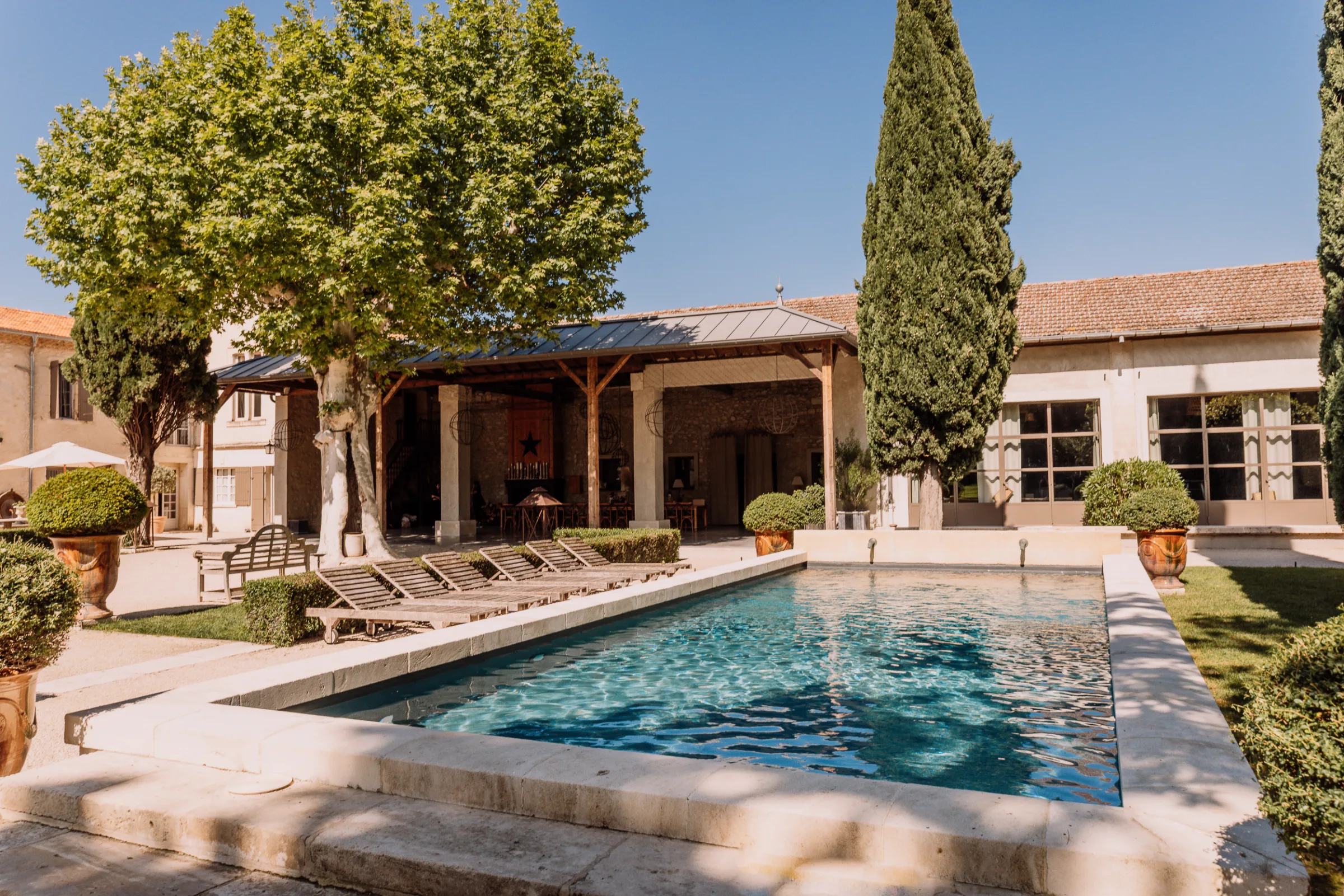 Swimming pool and courtyard at Le Mas d'Arvieux, a Provence wedding venue near Avignon.