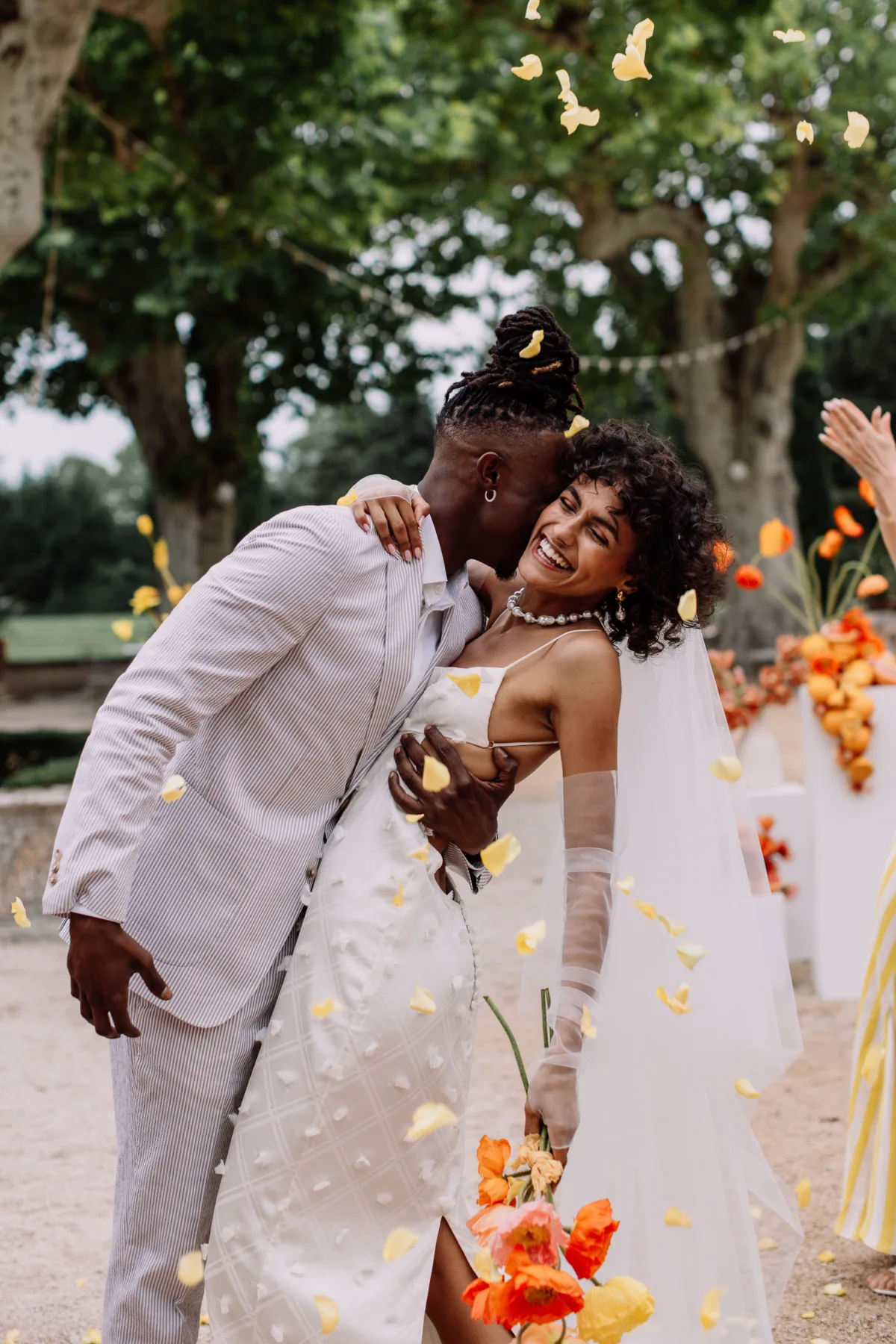 Happy and smiling super cool model Black bride and groom smiling after their staged wedding ceremony at Mas d’Arvieux in Provence, France