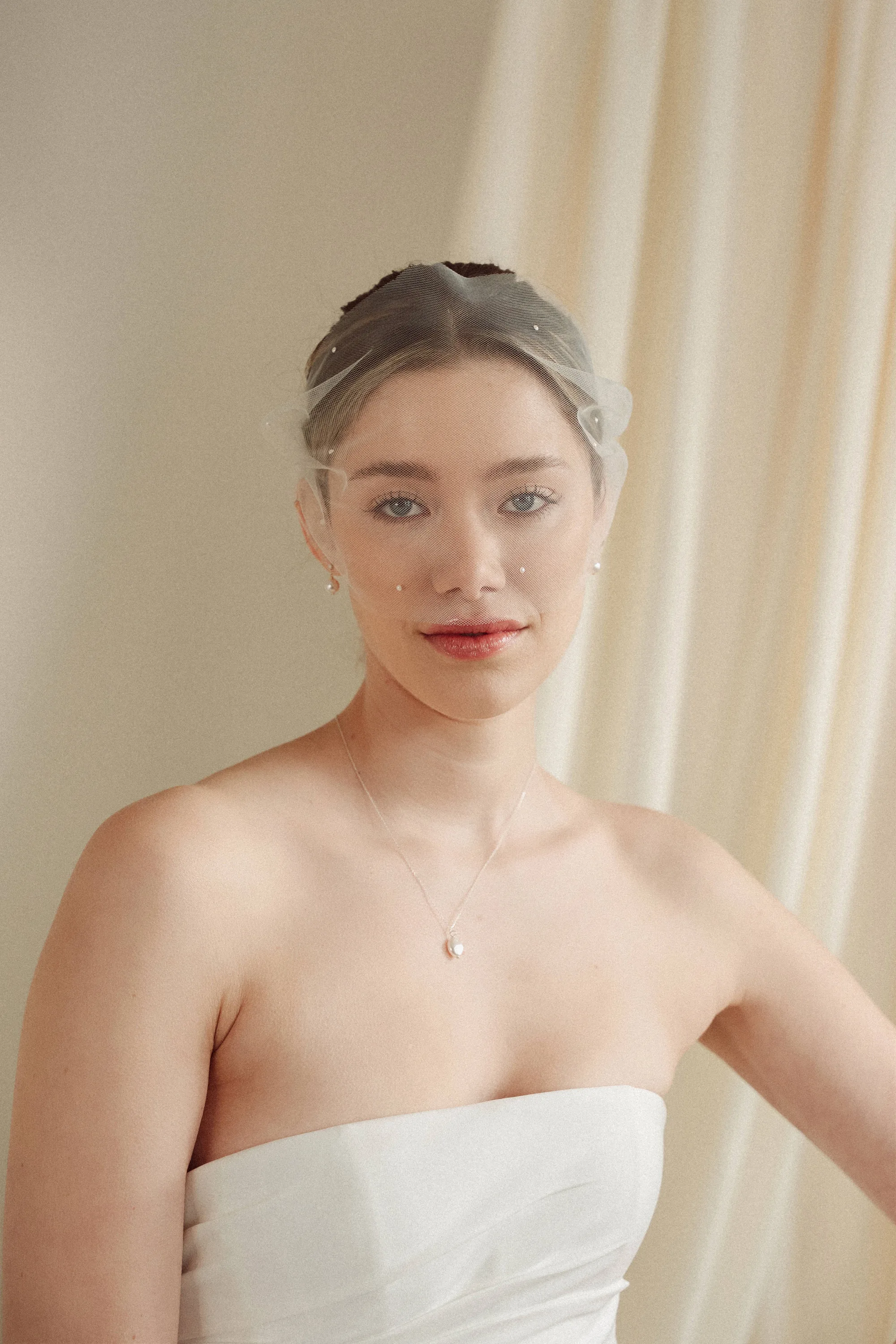 Rose pearl tulle mask Dina pearl stud drop earrings and Connie pearl necklace 2 - Muse, by Debbie Carlisle: Bridal Accessories & Micro Veils, Handmade & Shipped Worldwide Debbie Carlisle micro veil positioned across the face.