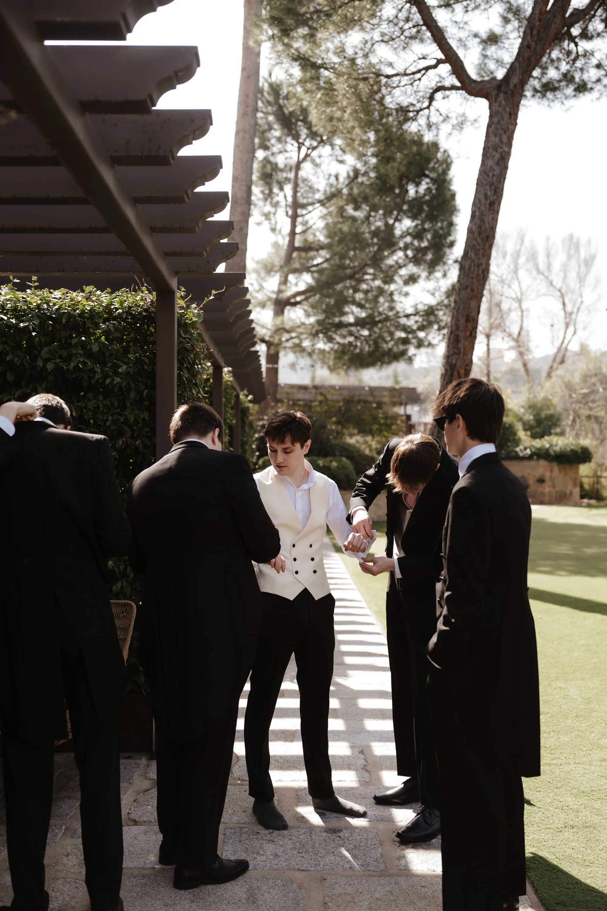 Wedding Toledo Spain Sam Sparks Photography 32 - A Multicultural Wedding in Toledo, Spain, with Korean Heritage and Deep Southern Roots Groom in a white waistcoat having his cuff fastened outdoors