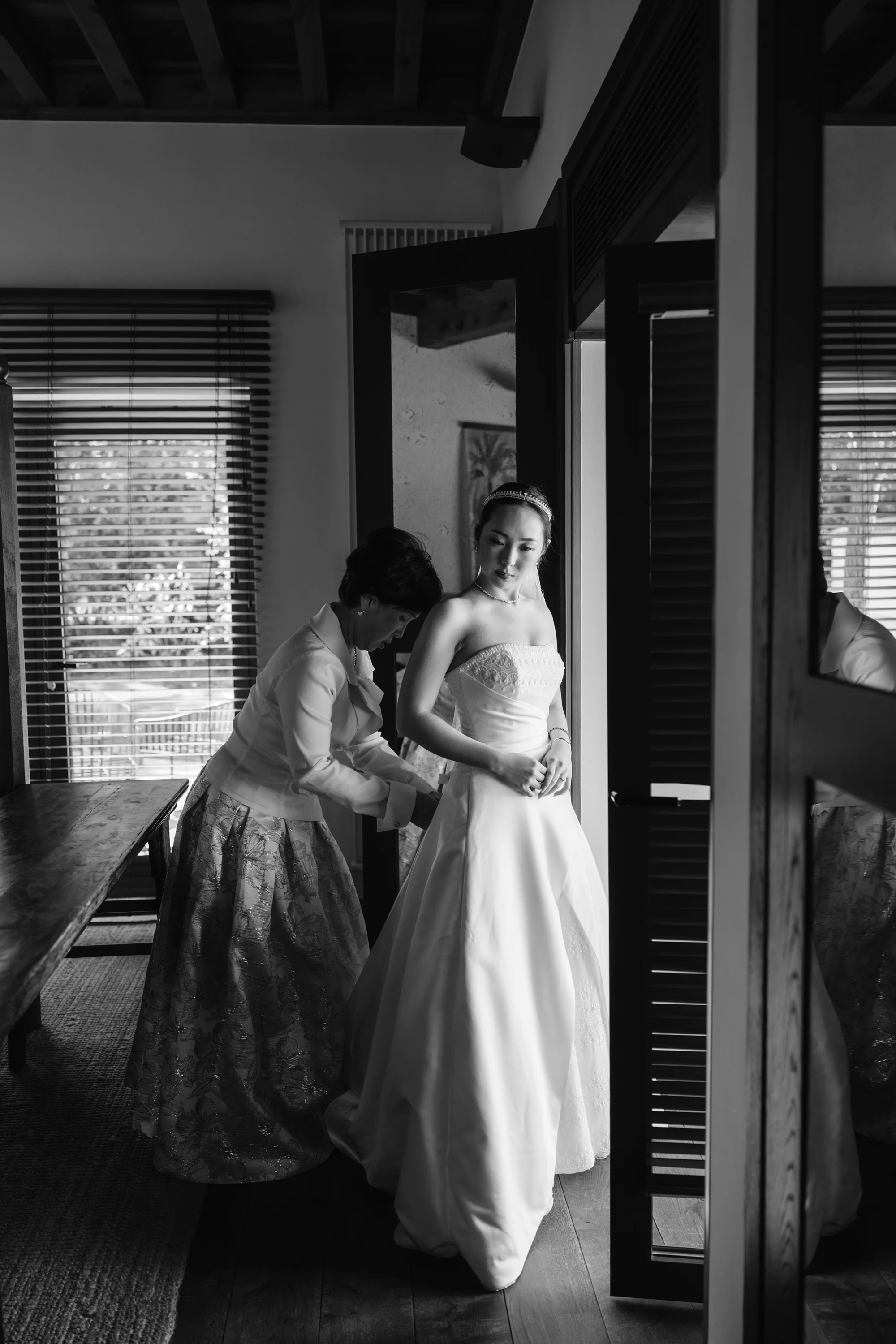 Wedding Toledo Spain Sam Sparks Photography 48 - A Multicultural Wedding in Toledo, Spain, with Korean Heritage and Deep Southern Roots Korean bride being assisted into her thrifted Maggie Sottero wedding dress by her mother.