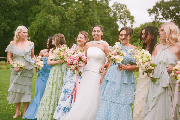 Bridesmaids in pastel colour dresses at Limekiln wedding venue - Home Lauren & Elliot’s Colourful Wedding at Limekiln Celebrating Indian Heritage