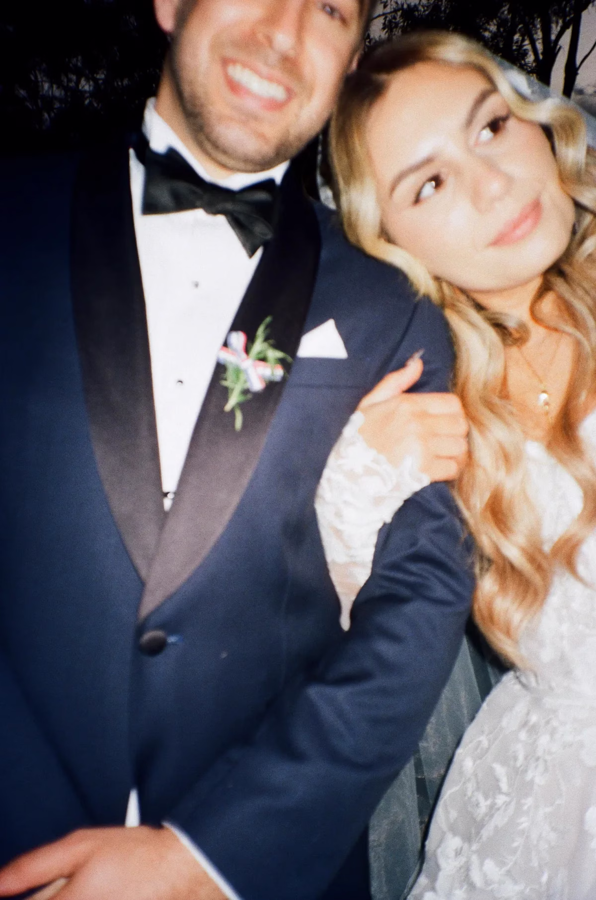 bride groom close up evening portrait the light photo and film 1 - The Light Photo & Film: 35mm Wedding Photography and Super 8 for Creative Couples Close-up of a smiling groom in a tuxedo with the bride leaning against his shoulder.