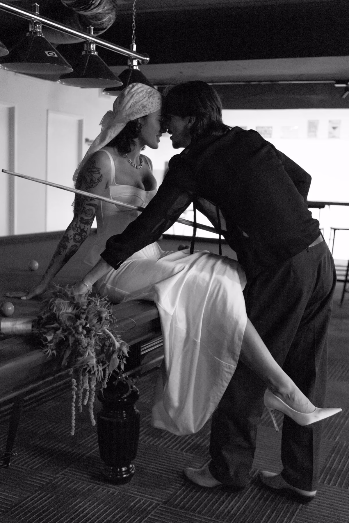 bride groom pool table portrait the light photo and film - The Light Photo & Film: 35mm Wedding Photography and Super 8 for Creative Couples Black and white photograph of a bride in a lace headscarf laughing with the groom outside a doorway.