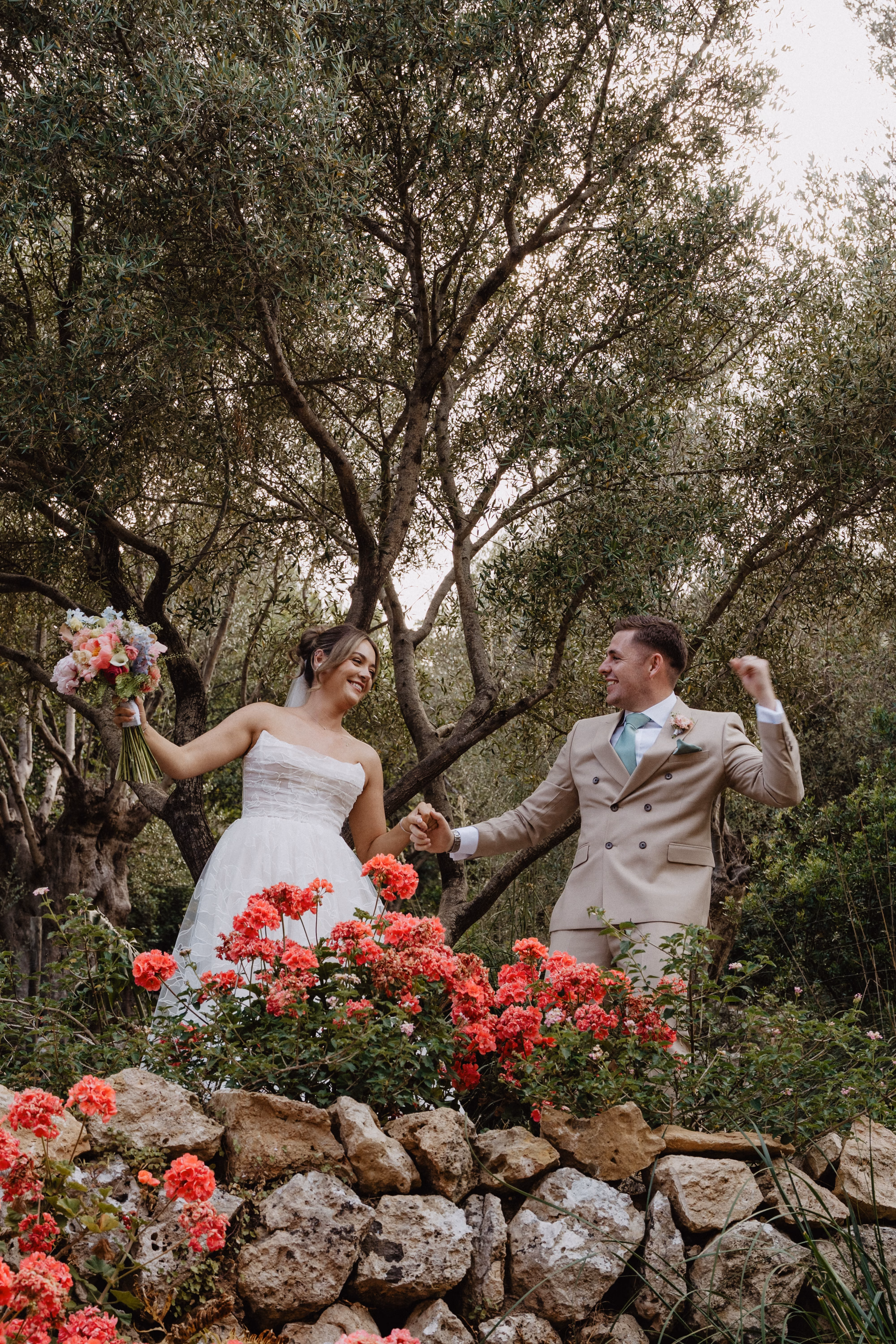 Bride and groom holding hands and looking happy at their wedding in Mallorca, planned by Dybiec Wedding